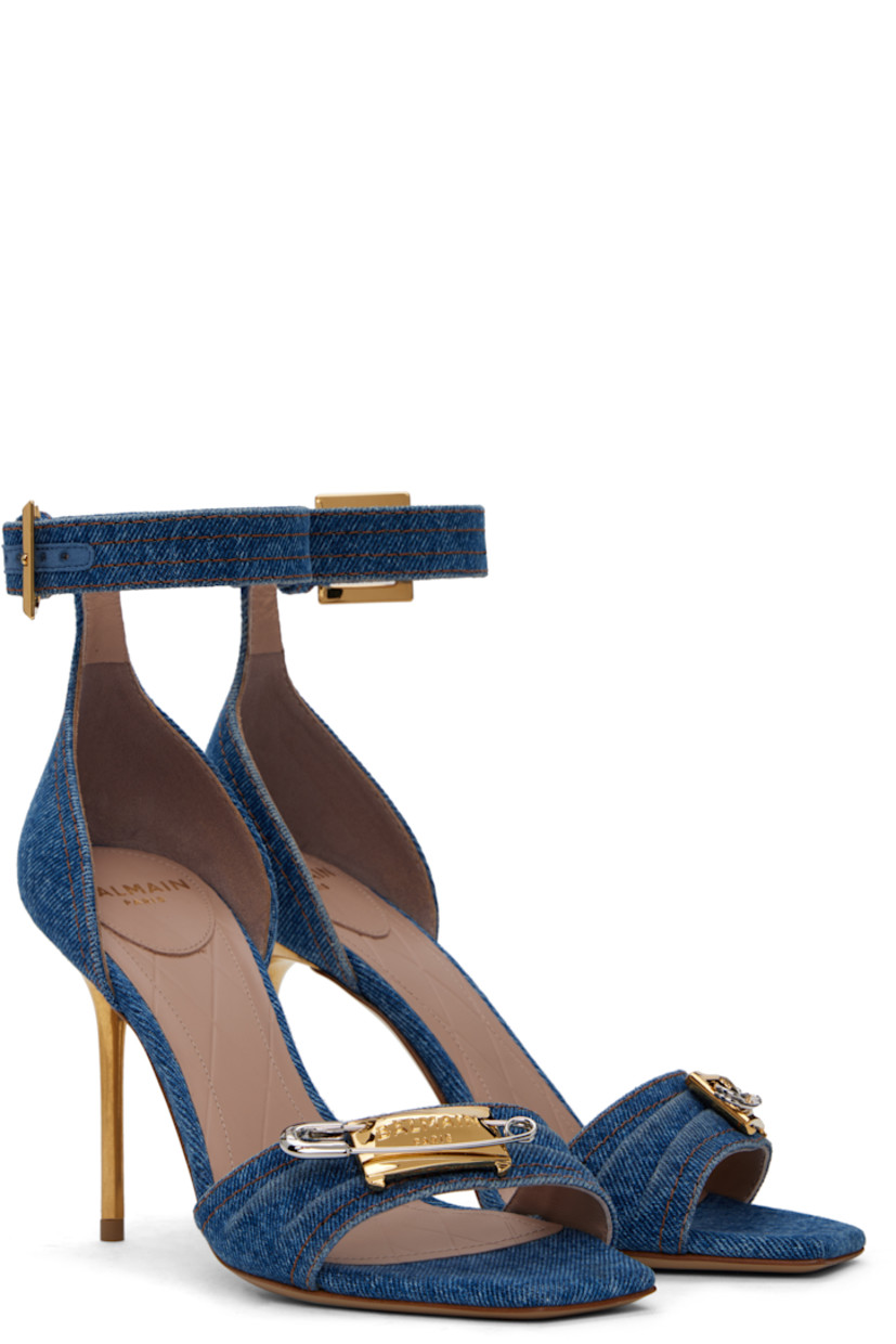 Denim heeled sandals in blue.

· Open square toe
· Logo-engraved graphic hardware at vamp
· Pin-buckle ankle strap
· Logo stamp at padded goatskin footbed
· Buffed calfskin lining
· Metal stiletto heel with rubber injection
· Calfskin sole
· Contrast stitching in tan
· Heel: H3.5"

Supplier color: Blue