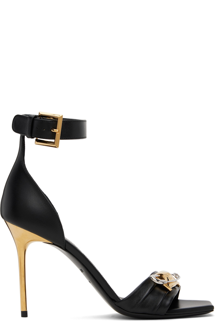 Buffed lambskin heeled sandals in black.

· Open square toe
· Logo-engraved graphic hardware at vamp
· Pin-buckle ankle strap
· Logo stamp at padded footbed
· Metal stiletto heel with rubber injection
· Leather sole
· Heel: H3.5"

Supplier color: Noir/Or/Argent