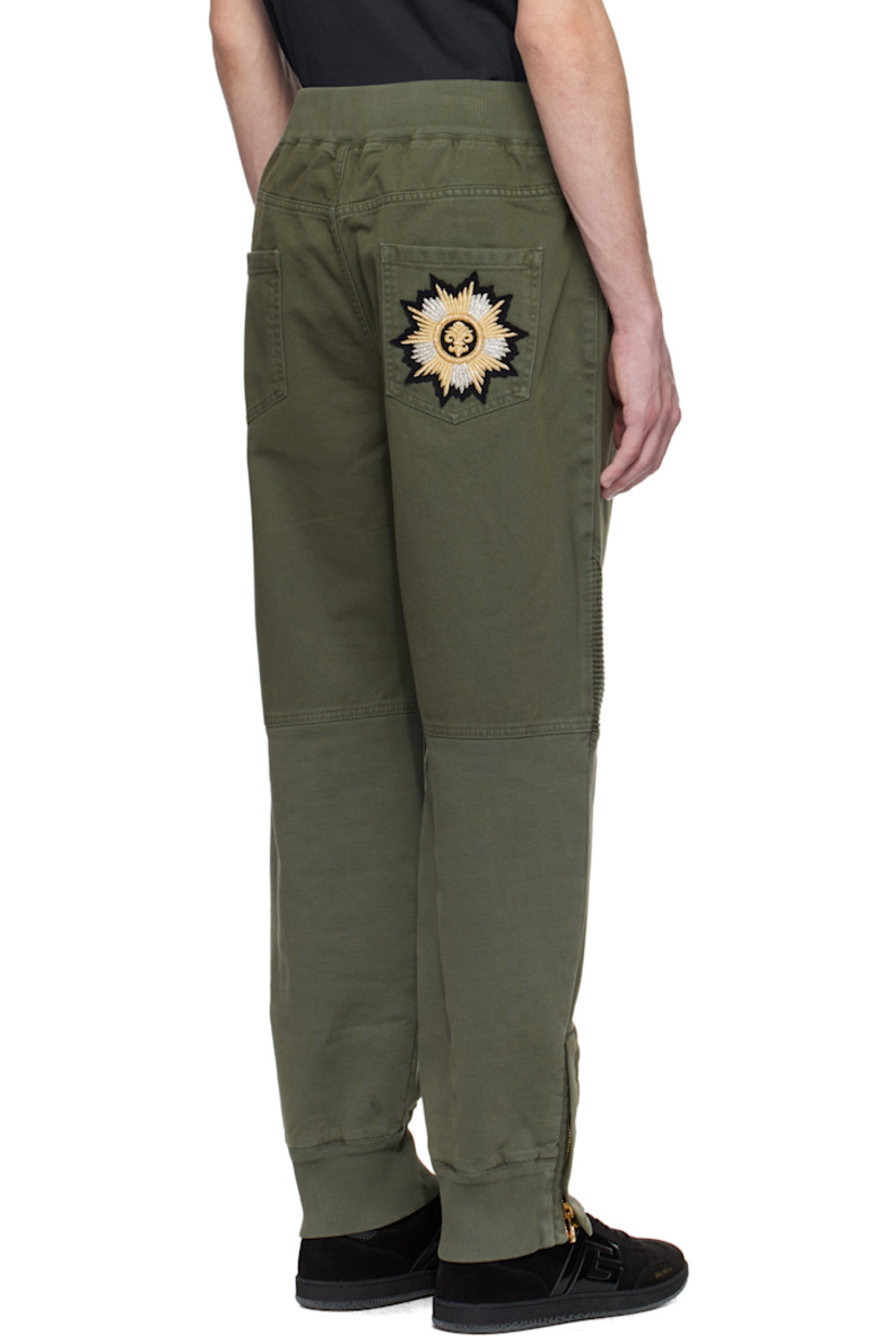 Loose-fit non-stretch denim and cotton jersey trousers.

· Paneled construction 
· Rib-knit elasticized waistband and cuffs
· Cord-lock drawstring at waistband
· Five-pocket styling
· Mock fly 
· Ribbed panel at knees 
· Zip vent at cuffs
· Embroidered and sequined graphic patch at back pocket 
· Logo-engraved gold-tone hardware 

Supplier color: Khaki