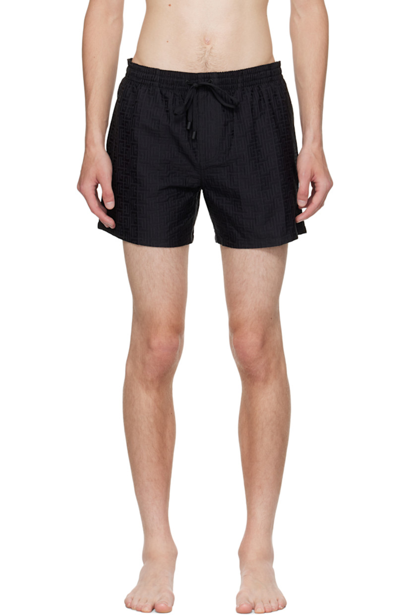 Twill swim shorts.

· Jacquard logo graphic pattern throughout 
· Drawstring at elasticized waistband 
· Three-pocket styling
· Mock fly 
· Grommets at back waist
· Mesh brief-style lining 

Supplier color: Black