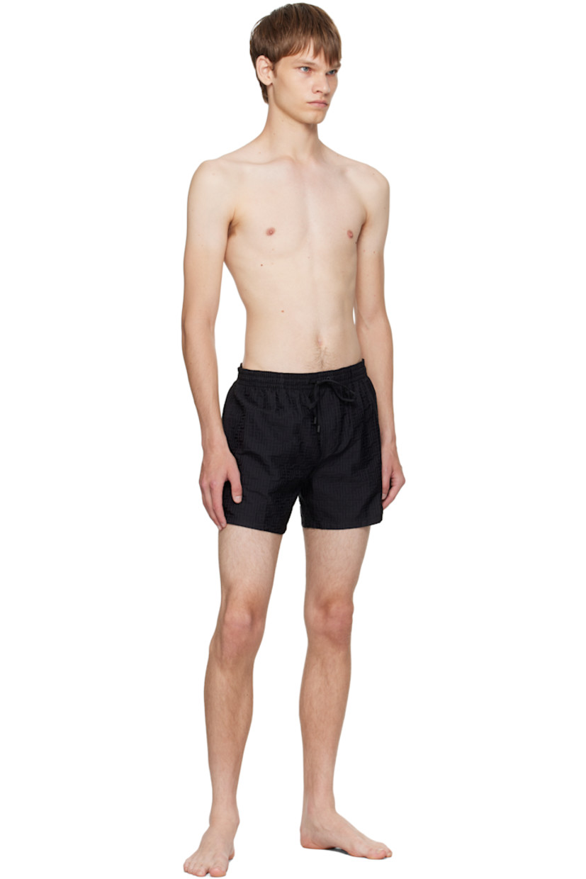 Twill swim shorts.

· Jacquard logo graphic pattern throughout 
· Drawstring at elasticized waistband 
· Three-pocket styling
· Mock fly 
· Grommets at back waist
· Mesh brief-style lining 

Supplier color: Black