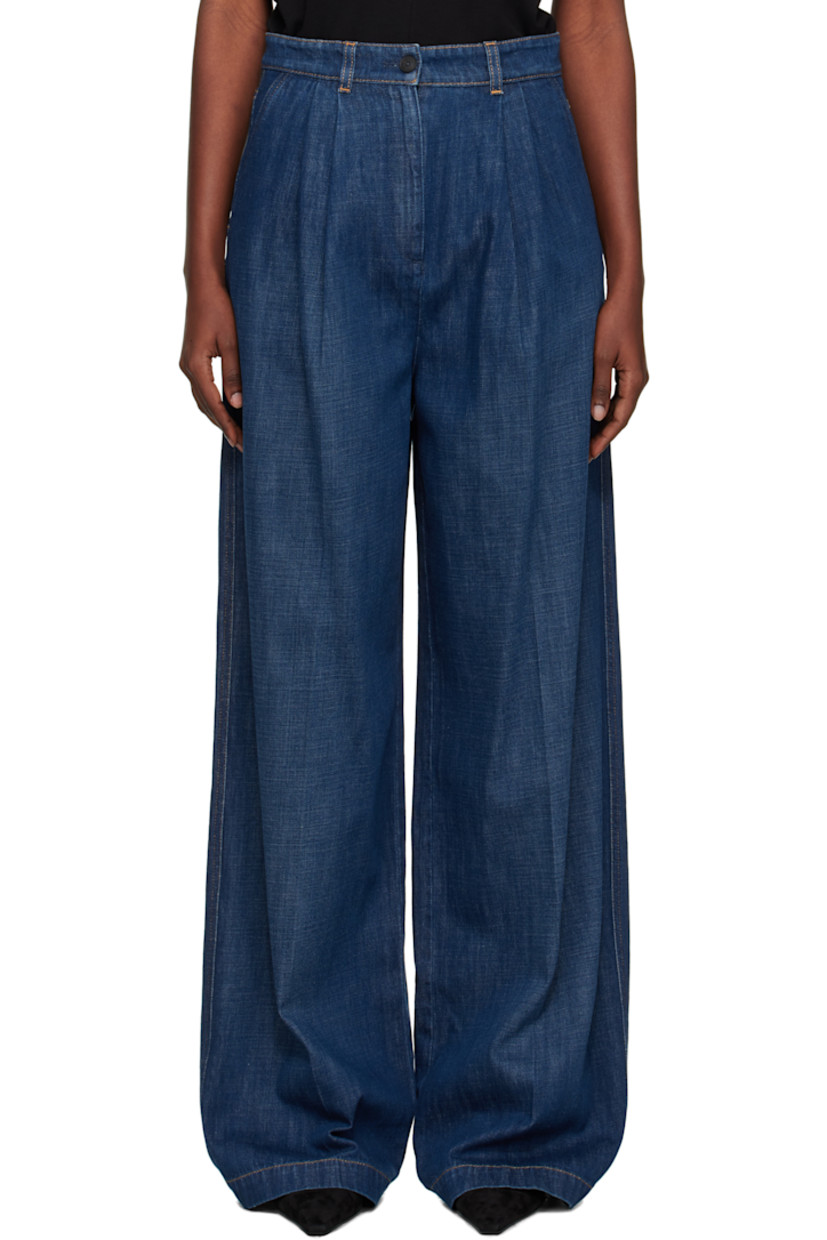 Hand-washed non-stretch denim jeans. 

· Wide-leg
· Subtle fading throughout
· Belt loops
· Four-pocket styling
· Zip fly
· Pleats at front 
· Creased legs
· Leather logo patch at back waistband
· Horn hardware
· Contrast stitching in tan

Supplier color: Medium blue