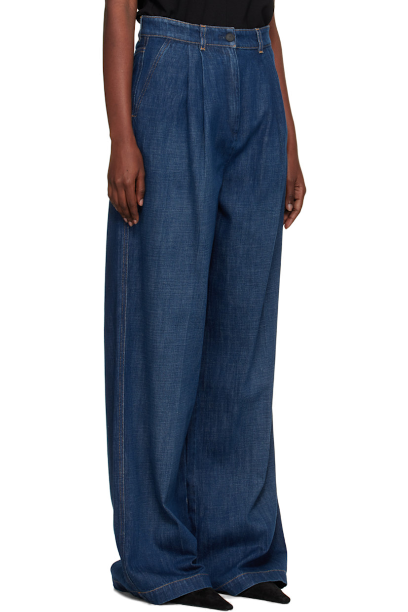 Hand-washed non-stretch denim jeans. 

· Wide-leg
· Subtle fading throughout
· Belt loops
· Four-pocket styling
· Zip fly
· Pleats at front 
· Creased legs
· Leather logo patch at back waistband
· Horn hardware
· Contrast stitching in tan

Supplier color: Medium blue