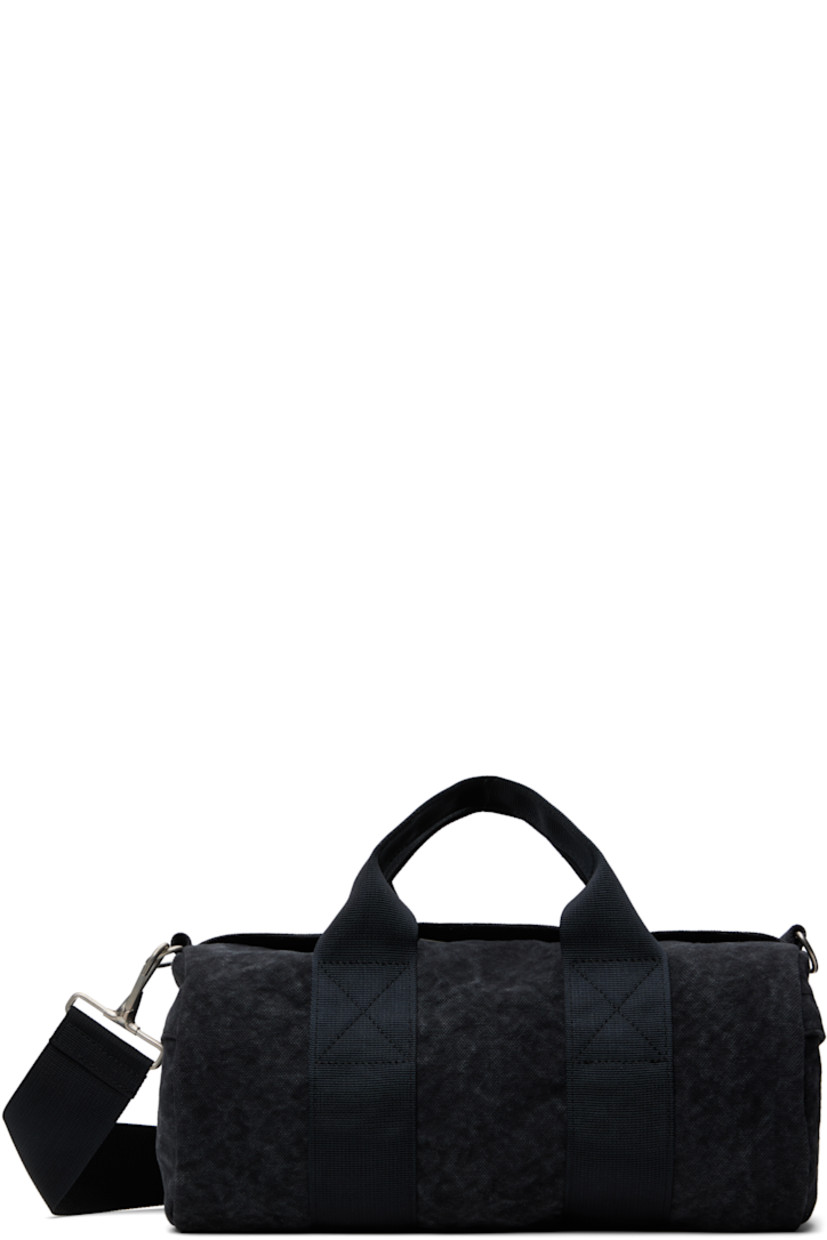 Piece-dyed cotton canvas duffle bag in tones of gray. Fading throughout.

· Twin carry handles
· Adjustable and detachable crossbody strap
· Zip pocket at sides
· Zip closure
· Patch pocket at interior
· H6" x W11" x D5.5"

Supplier color: Washed charcoal