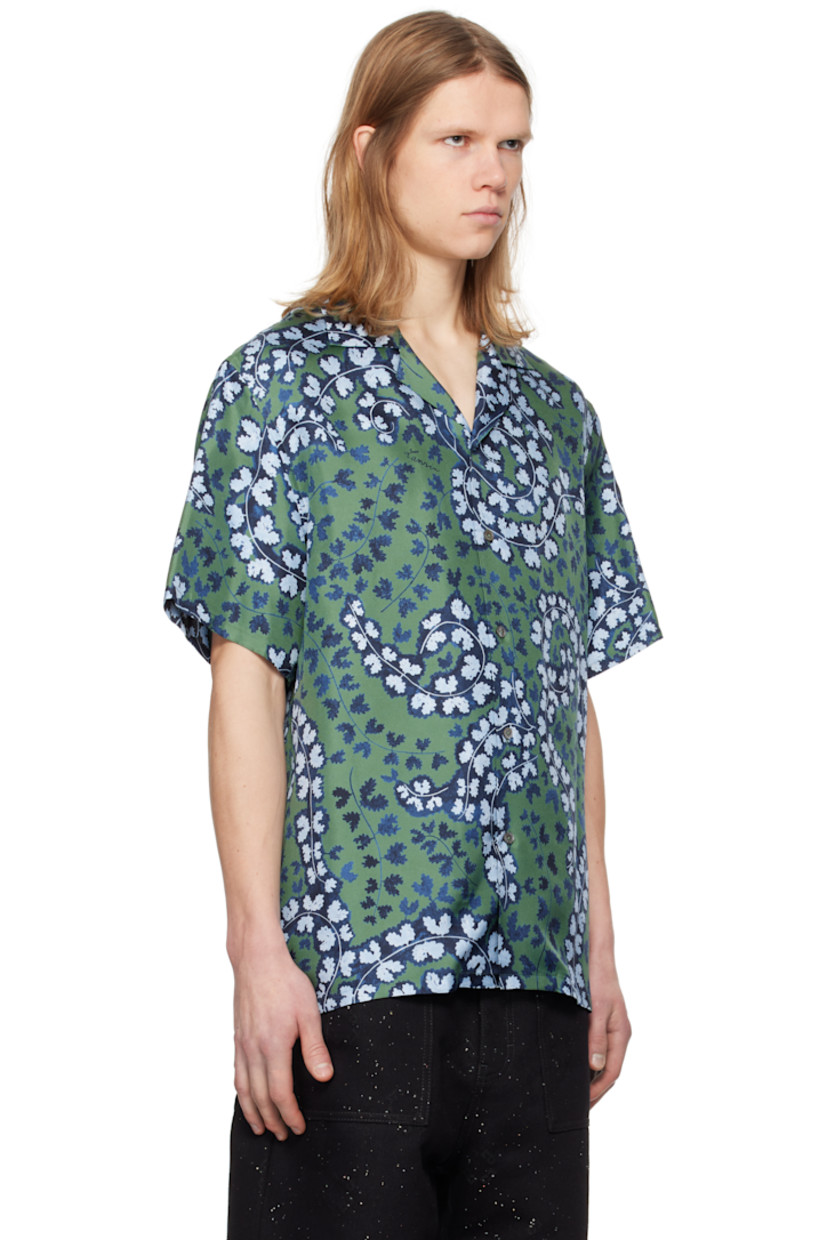 Silk twill shirt. Floral pattern and logos printed throughout.

· Open spread collar
· Button closure
· Logo-engraved mother-of-pearl hardware

Supplier color: Meleze