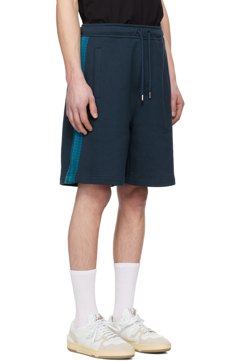 Cotton fleece shorts.

· Drawstring at elasticized waistband
· Three-pocket styling
· Embroidered logo at back pocket
· Chevron-woven webbing trim at outseams

Supplier color: Petrol blue