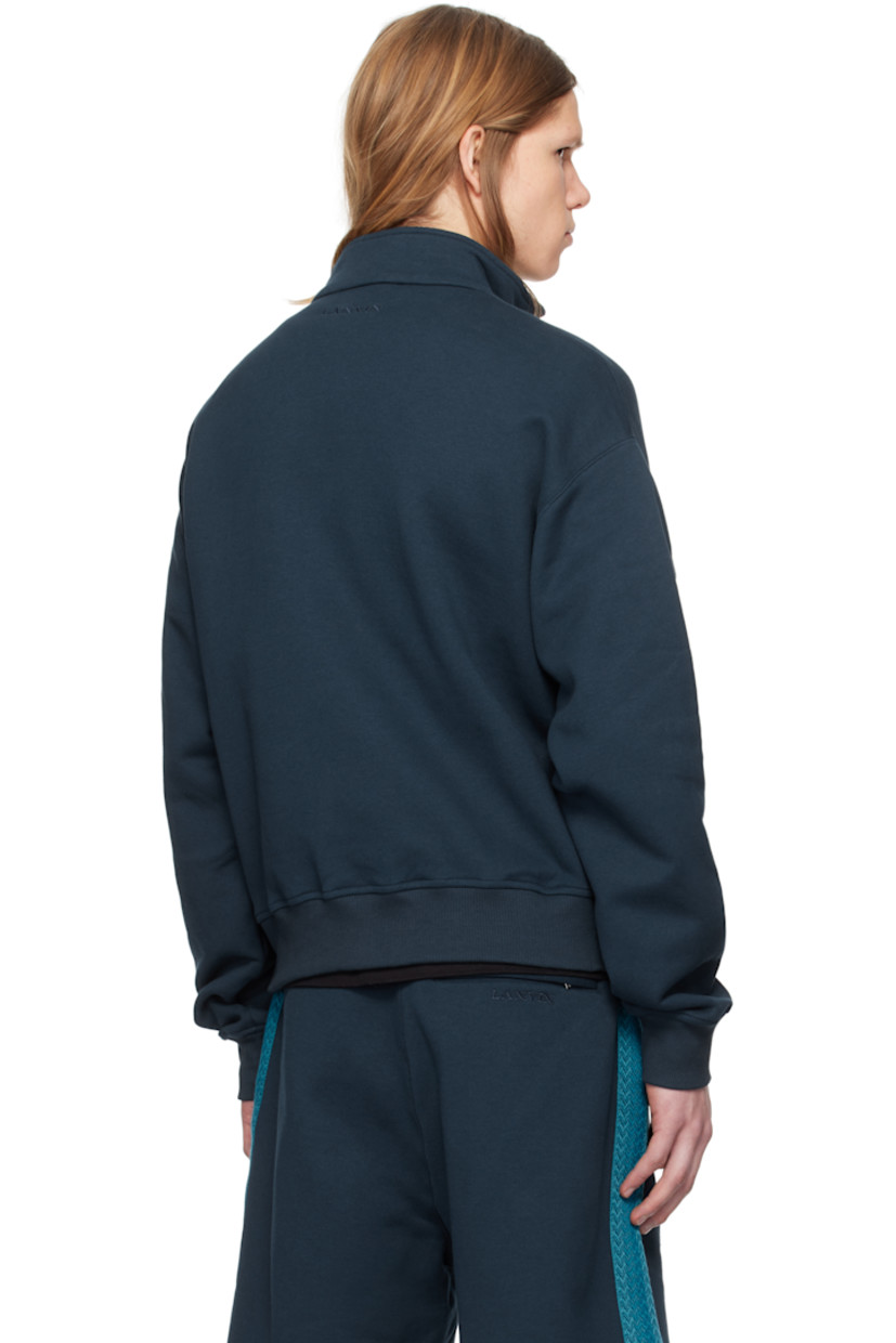 Cotton fleece track jacket.

· Stand collar
· Two-way zip closure
· Chevron-woven webbing trim at front
· Welt pockets
· Rib-knit hem and cuffs
· Logo embroidered at back collar

Supplier color: Petrol blue