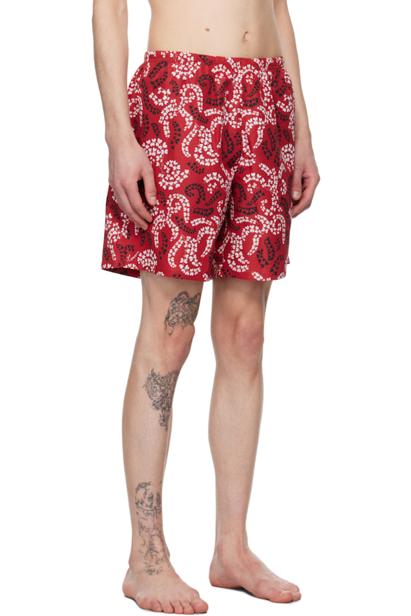Polyester taffeta swim shorts. Floral pattern printed throughout.

· Concealed drawstring at elasticized waistband
· Three-pocket styling
· Rubberized logo patch at back pocket 
· Briefs-style mesh lining

Supplier color: Carmine red
