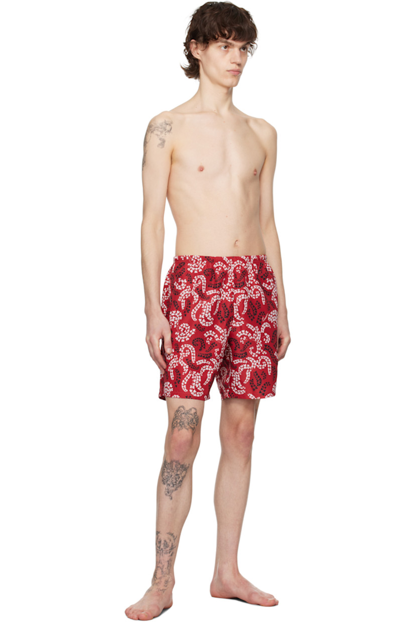 Polyester taffeta swim shorts. Floral pattern printed throughout.

· Concealed drawstring at elasticized waistband
· Three-pocket styling
· Rubberized logo patch at back pocket 
· Briefs-style mesh lining

Supplier color: Carmine red
