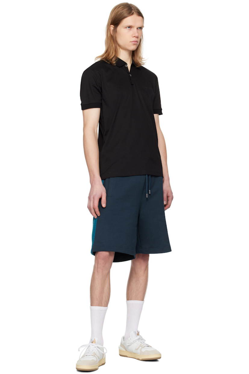 Mercerized cotton jersey polo.

· Rib-knit spread collar and cuffs
· Two-button placket
· Logo embroidered at chest
· Vented side seams

Supplier color: Black