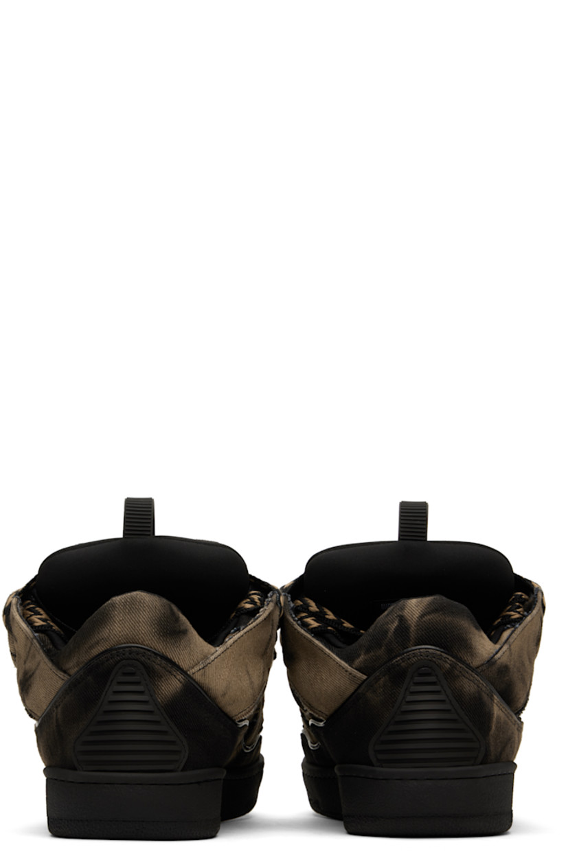 Low-top paneled denim and jersey sneakers in black and brown.

· Fading, piping, cutouts, and rubberized trim throughout
· Logo embossed at toe
· Lace-up closure
· Logo plaque and pull-loop at padded tongue
· Padded collar
· Jersey lining
· Treaded rubber sole

Supplier color: Black/Beige