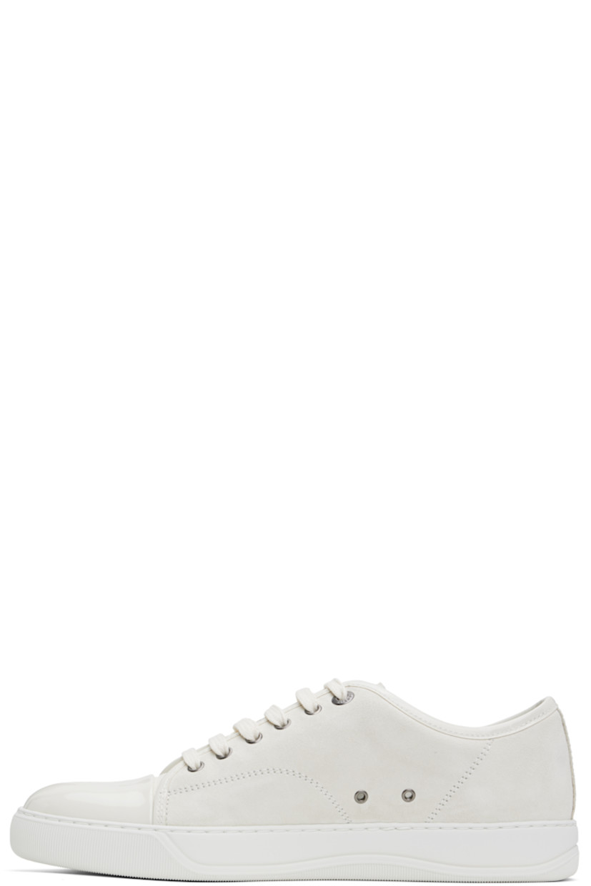 Low-top calfskin suede sneakers in off-white.

· Buffed calfskin trim throughout
· Cap toe
· Lace-up closure
· Padded tongue
· Eyelets at inner side
· Buffed calfskin and suede lining
· Treaded rubber sole

Supplier color: Ecru