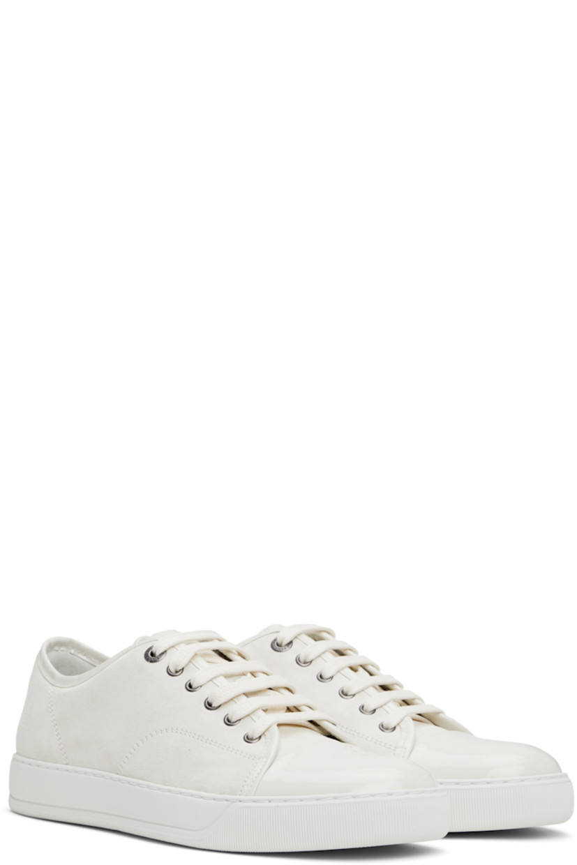 Low-top calfskin suede sneakers in off-white.

· Buffed calfskin trim throughout
· Cap toe
· Lace-up closure
· Padded tongue
· Eyelets at inner side
· Buffed calfskin and suede lining
· Treaded rubber sole

Supplier color: Ecru