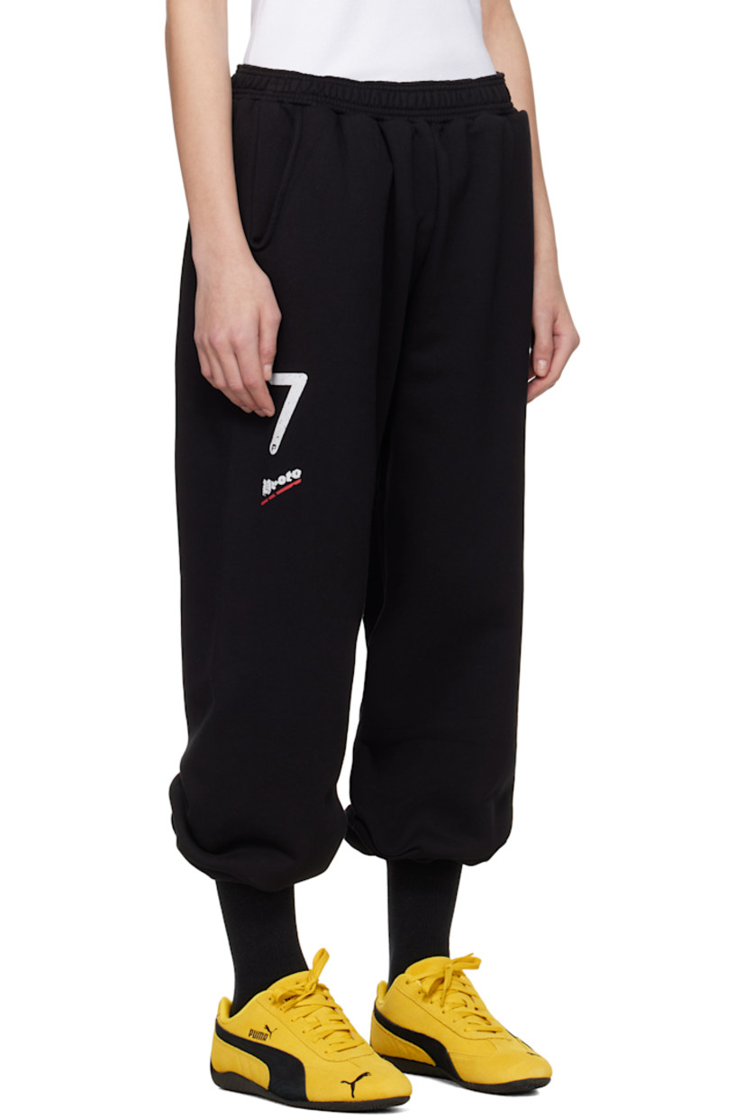 Upcycled French terry lounge pants.

· Concealed drawstring at elasticized waistband
· Two-pocket styling
· Logo and text printed at leg
· Cropped legs
· Raw edge at cuffs
· Logo flag at back waistband

Each item is unique. Please note coloration and finishings may vary.

Supplier color: Black molleton