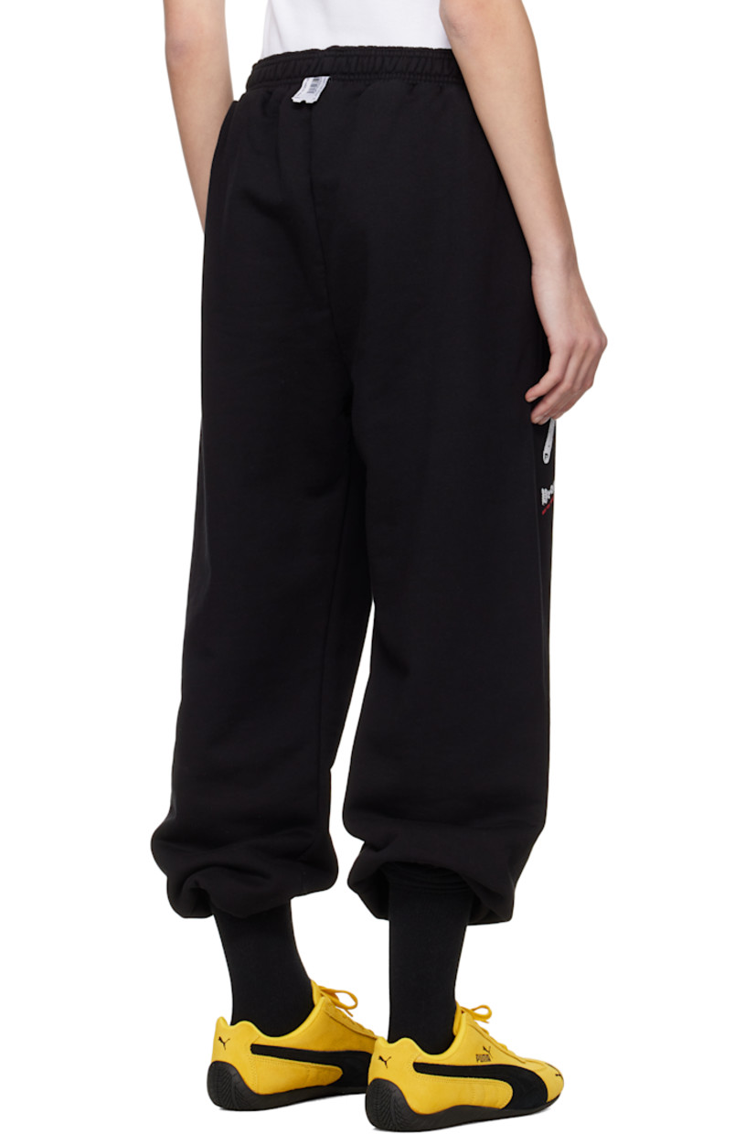 Upcycled French terry lounge pants.

· Concealed drawstring at elasticized waistband
· Two-pocket styling
· Logo and text printed at leg
· Cropped legs
· Raw edge at cuffs
· Logo flag at back waistband

Each item is unique. Please note coloration and finishings may vary.

Supplier color: Black molleton
