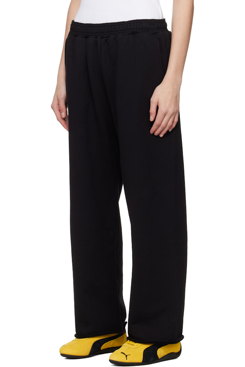 Upcycled French terry lounge pants.

· Concealed drawstring at elasticized waistband
· Two-pocket styling
· Logo and text printed at leg
· Cropped legs
· Raw edge at cuffs
· Logo flag at back waistband

Each item is unique. Please note coloration and finishings may vary.

Supplier color: Black molleton