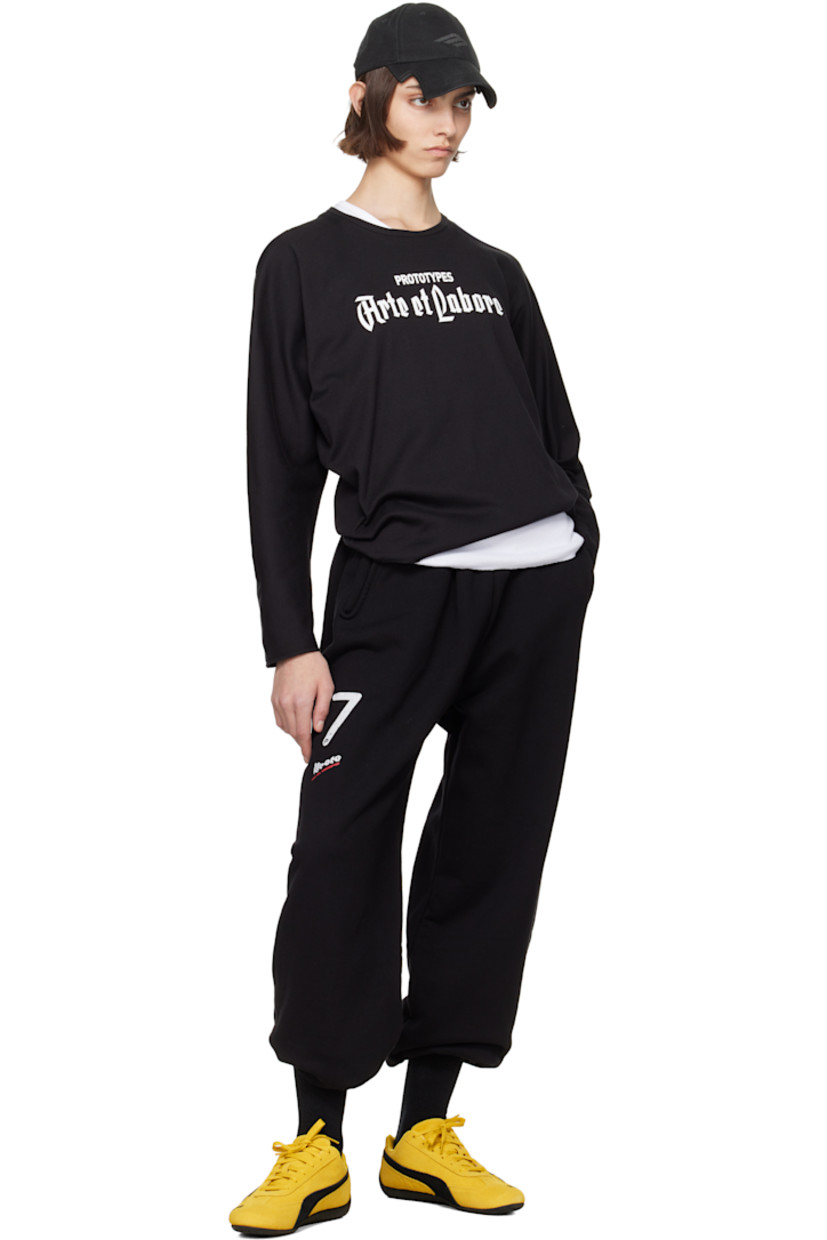 Upcycled French terry lounge pants.

· Concealed drawstring at elasticized waistband
· Two-pocket styling
· Logo and text printed at leg
· Cropped legs
· Raw edge at cuffs
· Logo flag at back waistband

Each item is unique. Please note coloration and finishings may vary.

Supplier color: Black molleton