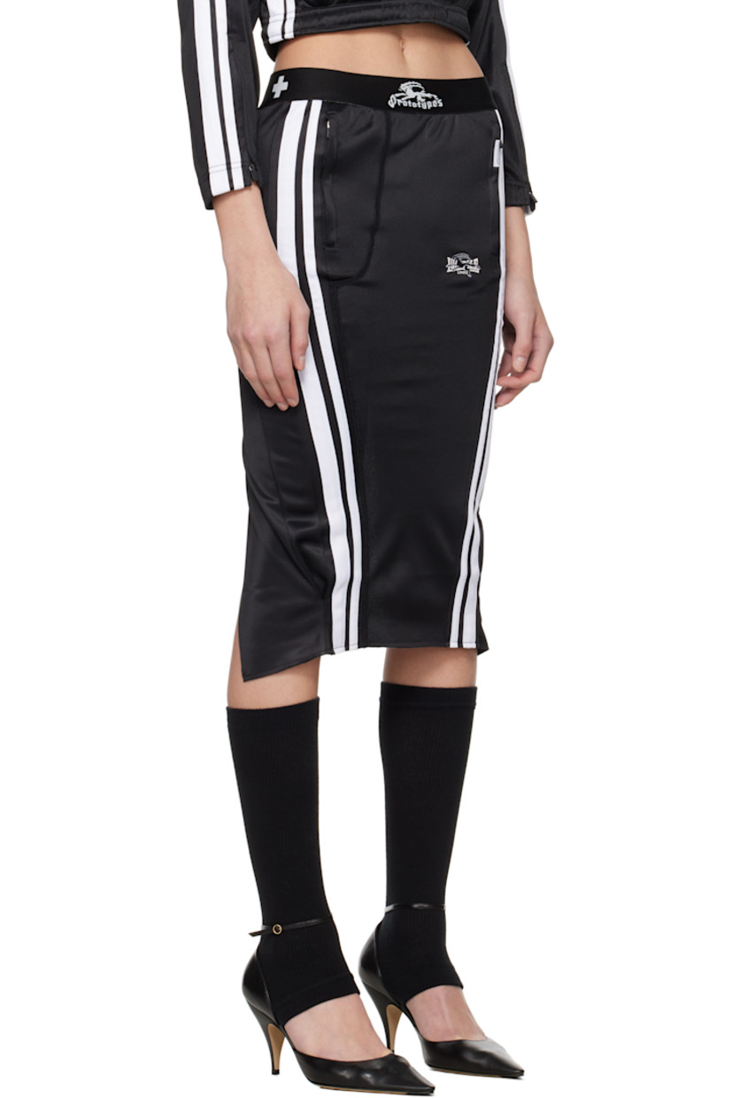 Upcycled polyester jersey midi skirt. 

· Logo-woven elasticized waistband
· Two-pocket styling
· Logo patch at pocket
· Stripes and embroidered logo at front
· Logo flag at back waistband
· Curved vent at back 

Each item is unique. Please note coloration and finishings may vary.

Supplier color: Tracksuit black