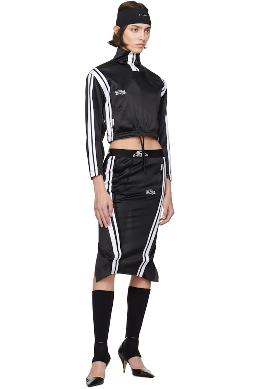 Upcycled polyester jersey midi skirt. 

· Logo-woven elasticized waistband
· Two-pocket styling
· Logo patch at pocket
· Stripes and embroidered logo at front
· Logo flag at back waistband
· Curved vent at back 

Each item is unique. Please note coloration and finishings may vary.

Supplier color: Tracksuit black