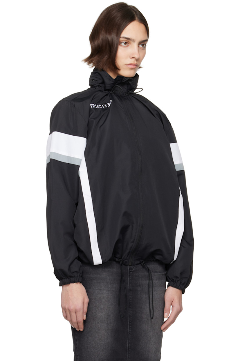 Upcycled polyester ripstop jacket. Stripes throughout. 

· Elasticized stowaway hood
· Bungee-style drawstring at stand collar and hem
· Zip closure
· Zip pockets
· Raglan sleeves
· Elasticized cuffs
· Logo flag at back collar
· Open back

Each item is unique. Please note coloration and finishings may vary.

Supplier color: Nylon track black