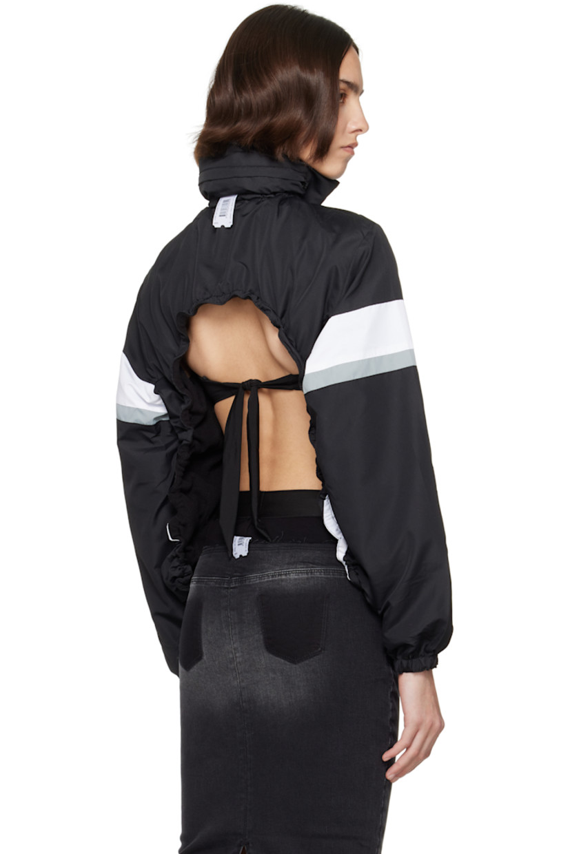 Upcycled polyester ripstop jacket. Stripes throughout. 

· Elasticized stowaway hood
· Bungee-style drawstring at stand collar and hem
· Zip closure
· Zip pockets
· Raglan sleeves
· Elasticized cuffs
· Logo flag at back collar
· Open back

Each item is unique. Please note coloration and finishings may vary.

Supplier color: Nylon track black