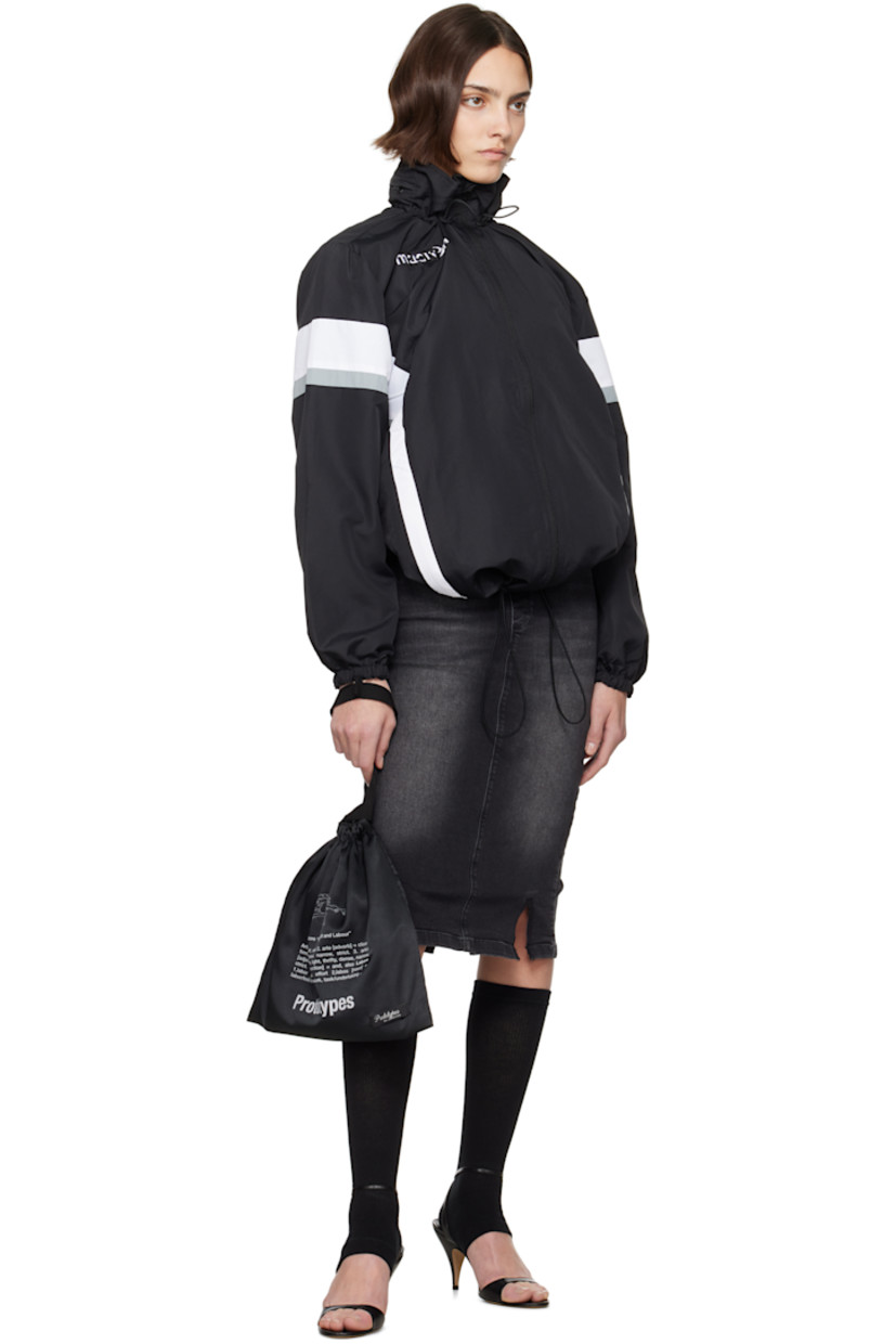 Upcycled polyester ripstop jacket. Stripes throughout. 

· Elasticized stowaway hood
· Bungee-style drawstring at stand collar and hem
· Zip closure
· Zip pockets
· Raglan sleeves
· Elasticized cuffs
· Logo flag at back collar
· Open back

Each item is unique. Please note coloration and finishings may vary.

Supplier color: Nylon track black