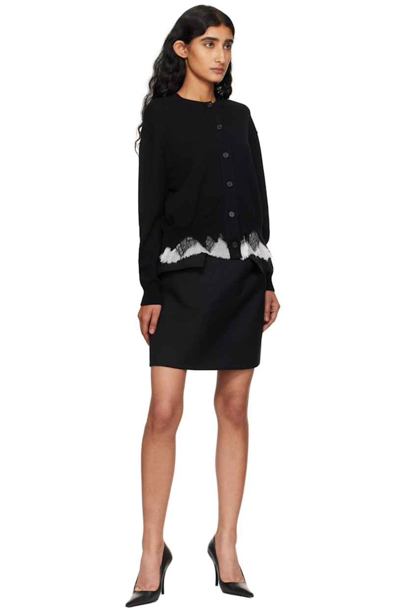 Knit wool- and cashmere-blend cardigan.

· Pre-shrunk 
· Rib-knit crewneck, hem, and cuffs
· Button closure
· Lace and silk crepon trim with raw edges at hem 

Supplier color: Black