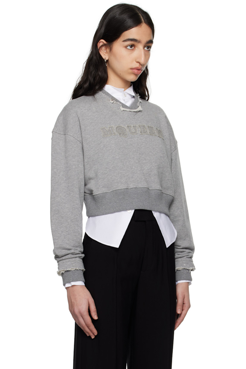 French terry sweatshirt.

· Frayed edge at rib-knit crewneck and cuffs
· Hand-embroidered logo appliqué at chest
· Rib-knit cropped hem
· Dropped shoulders

Supplier color: Grey melange