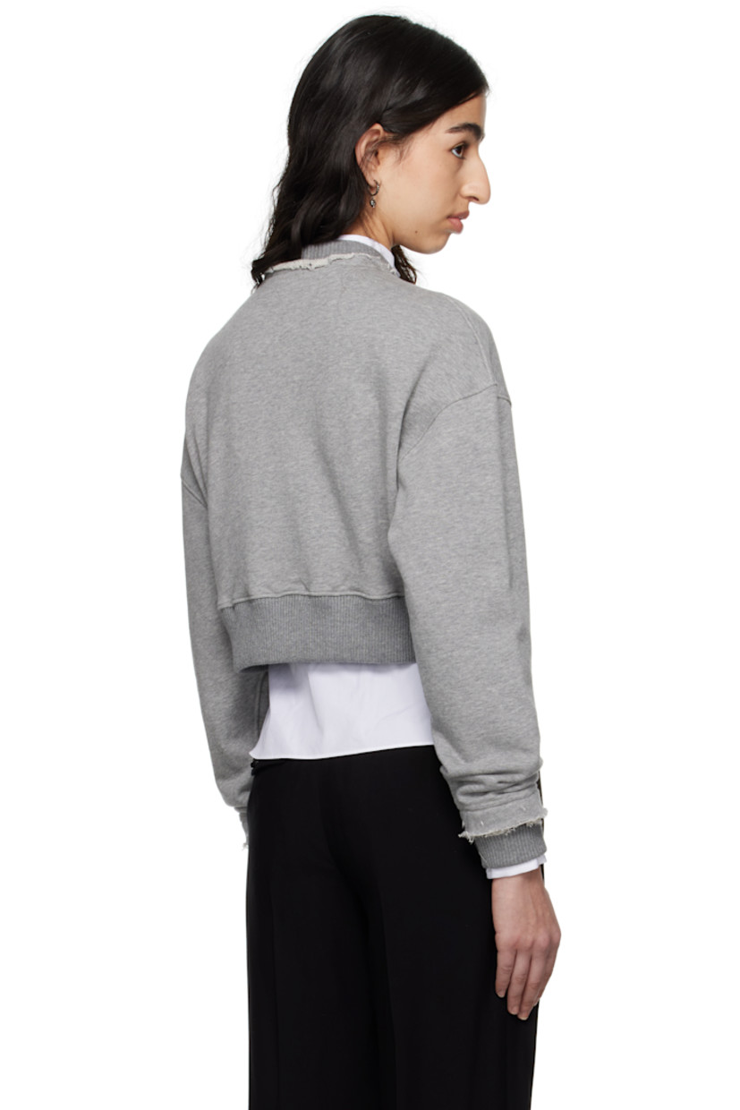 French terry sweatshirt.

· Frayed edge at rib-knit crewneck and cuffs
· Hand-embroidered logo appliqué at chest
· Rib-knit cropped hem
· Dropped shoulders

Supplier color: Grey melange