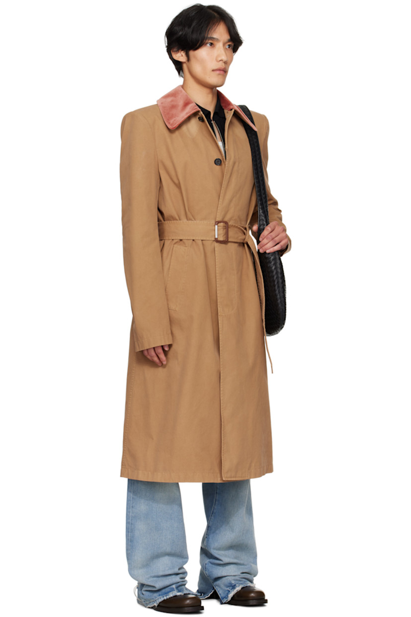Organic cotton twill trench coat.

· Velvet spread collar
· Concealed button closure
· Detachable cinch belt
· Welt pockets at waist
· Padded shoulders
· Belt loops at back waist
· Button vent at back hem
· Welt pocket at interior
· Full cotton- and cupro-blend cavalry twill lining
· Horn hardware

Supplier color: Sand