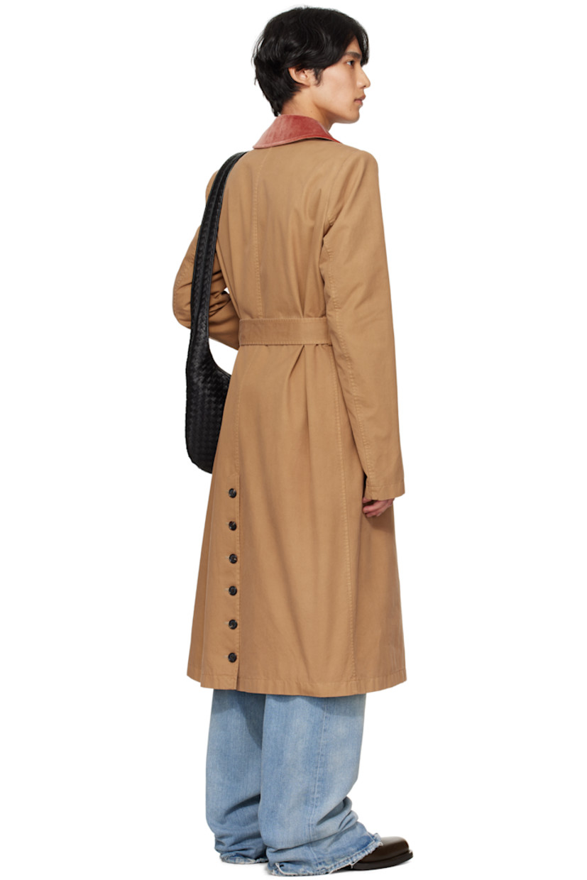 Organic cotton twill trench coat.

· Velvet spread collar
· Concealed button closure
· Detachable cinch belt
· Welt pockets at waist
· Padded shoulders
· Belt loops at back waist
· Button vent at back hem
· Welt pocket at interior
· Full cotton- and cupro-blend cavalry twill lining
· Horn hardware

Supplier color: Sand