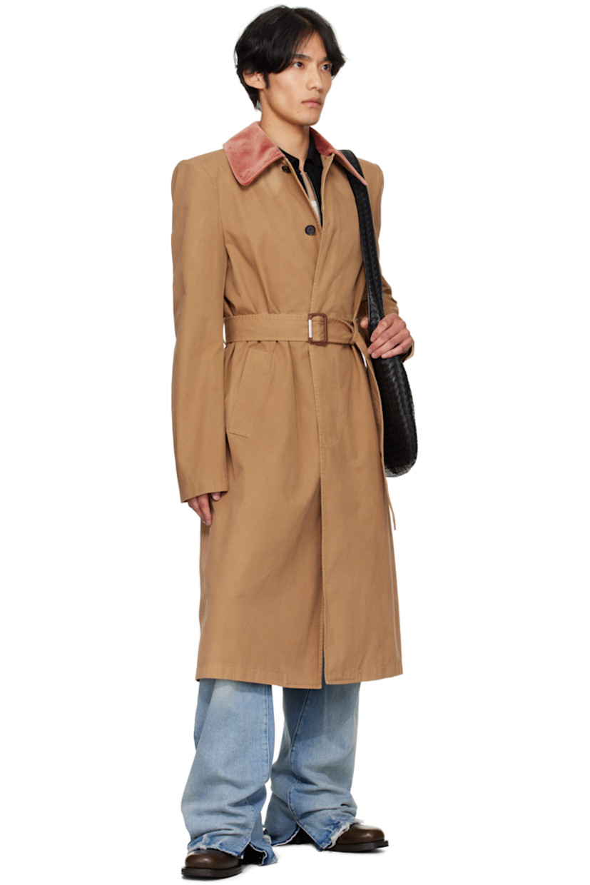 Organic cotton twill trench coat.

· Velvet spread collar
· Concealed button closure
· Detachable cinch belt
· Welt pockets at waist
· Padded shoulders
· Belt loops at back waist
· Button vent at back hem
· Welt pocket at interior
· Full cotton- and cupro-blend cavalry twill lining
· Horn hardware

Supplier color: Sand