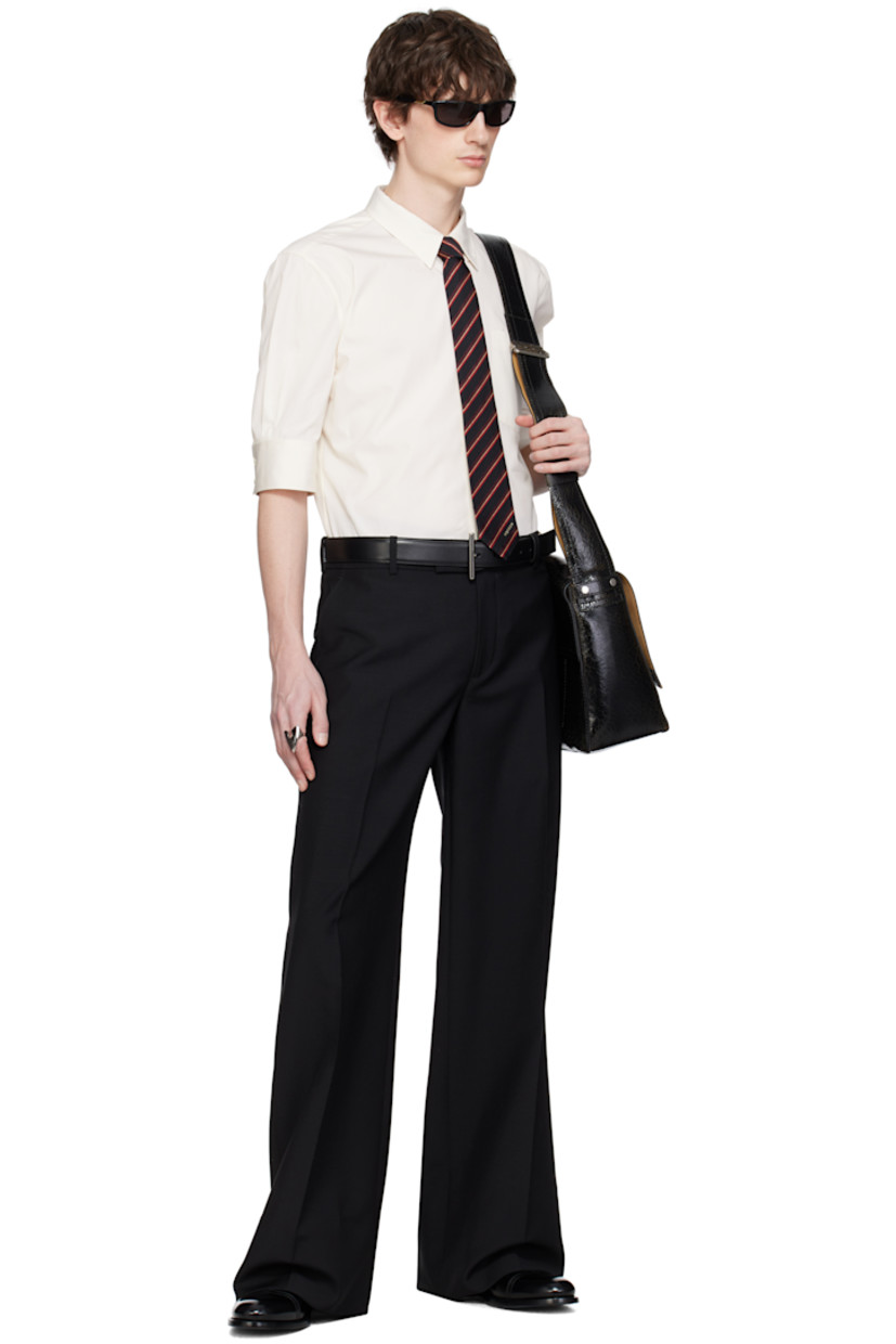 Cotton poplin shirt.

· Spread collar with concealed button-down fastening
· Button closure
· Patch pocket
· Shirttail hem
· Buttoned barrel cuffs
· Twin pleats at yoke 

Supplier color: Ivory