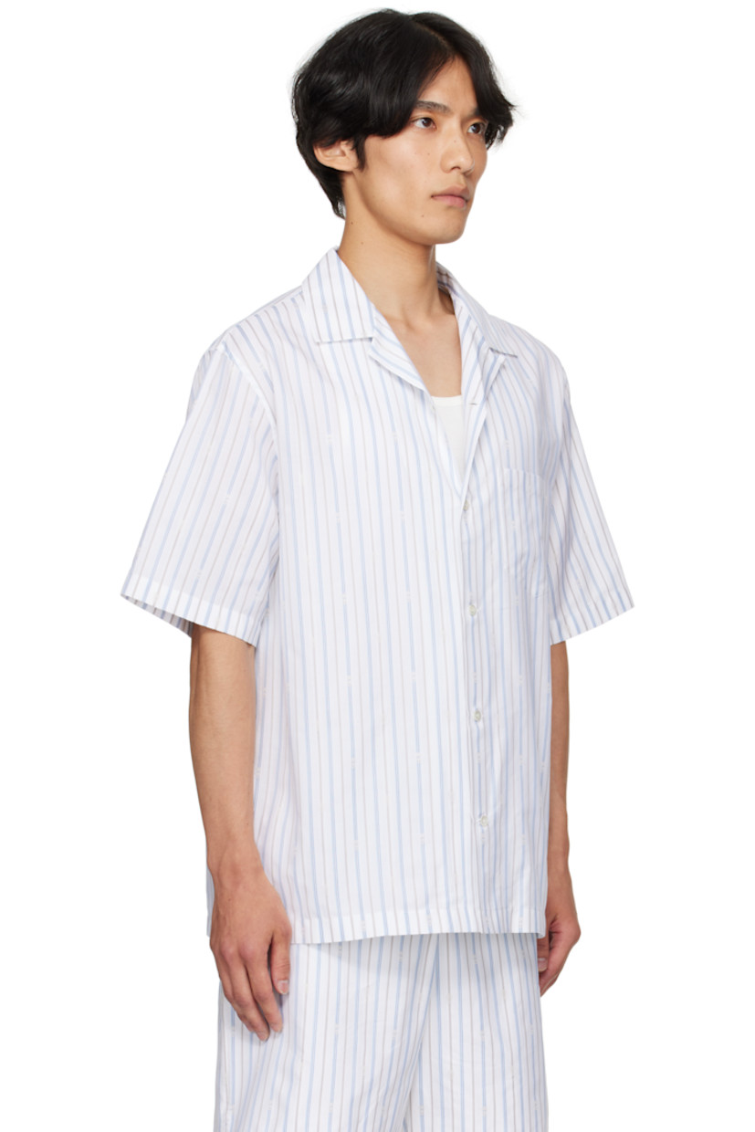Cotton poplin shirt.

· Striped logo pattern throughout
· Open spread collar
· Button closure
· Patch pocket at chest
· Vented side seams
· Twin pleats at back yoke
· Mother-of-pearl hardware

Supplier color: White/Blue/Grey