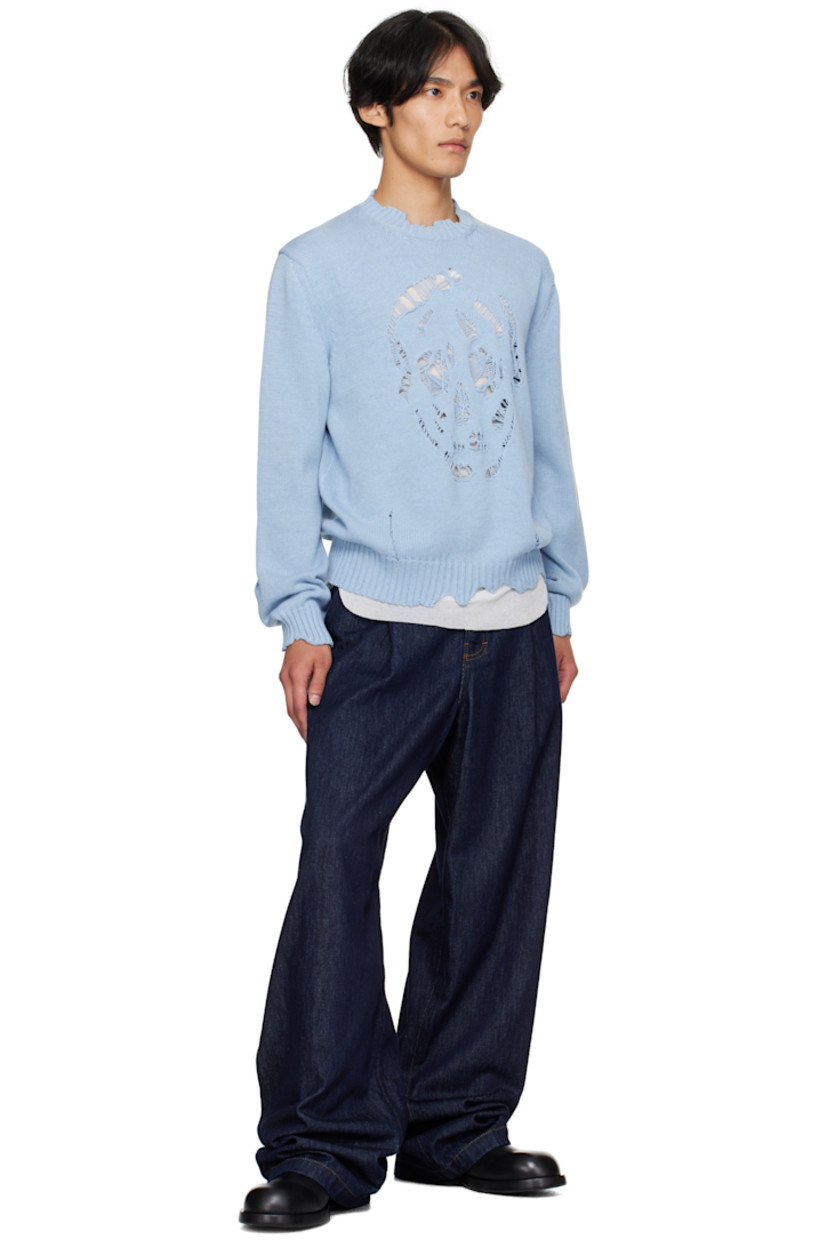 Knit cotton sweater.

· Distressing and laddering throughout
· Rib-knit crewneck, hem, and cuffs
· Distressed graphic at front
· Dropped shoulders

Supplier color: Shirting blue