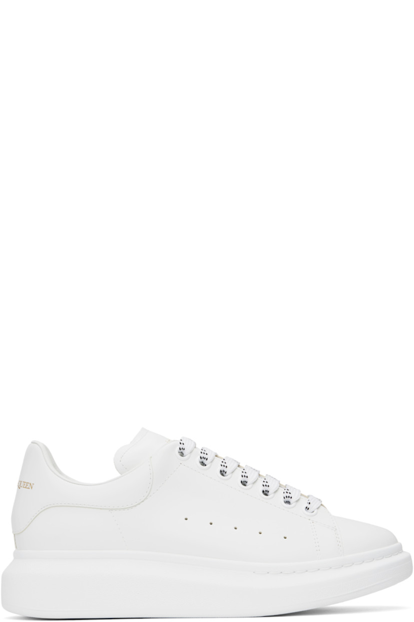 Low-top buffed calfskin sneakers in white.

· Lace-up closure
· Padded tongue and collar
· Gold-tone logo stamp at tongue and heel
· Perforations at sides
· Buffed calfskin lining
· Textured rubber midsole
· Treaded rubber sole

Supplier color: White/White