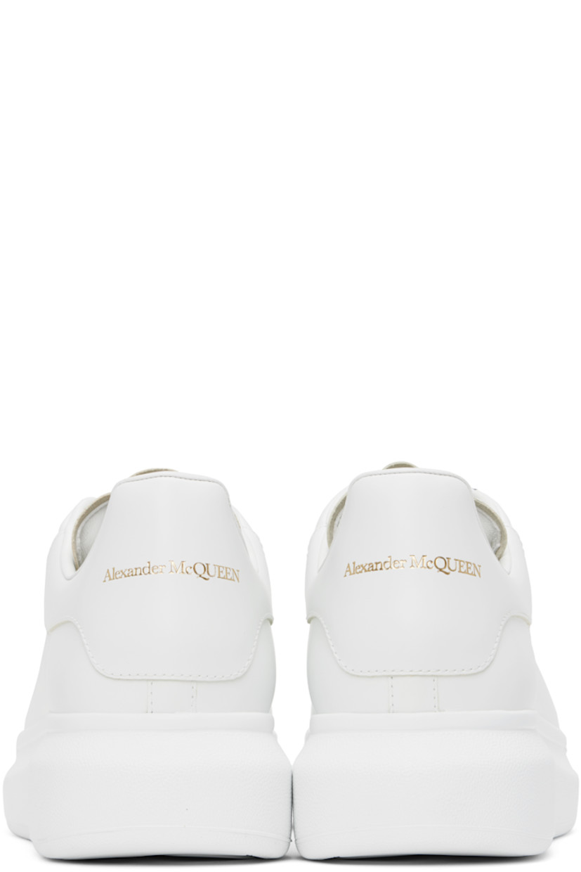 Low-top buffed calfskin sneakers in white.

· Lace-up closure
· Padded tongue and collar
· Gold-tone logo stamp at tongue and heel
· Perforations at sides
· Buffed calfskin lining
· Textured rubber midsole
· Treaded rubber sole

Supplier color: White/White