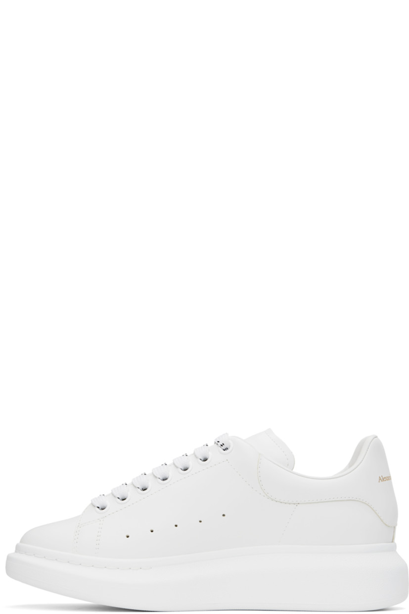 Low-top buffed calfskin sneakers in white.

· Lace-up closure
· Padded tongue and collar
· Gold-tone logo stamp at tongue and heel
· Perforations at sides
· Buffed calfskin lining
· Textured rubber midsole
· Treaded rubber sole

Supplier color: White/White