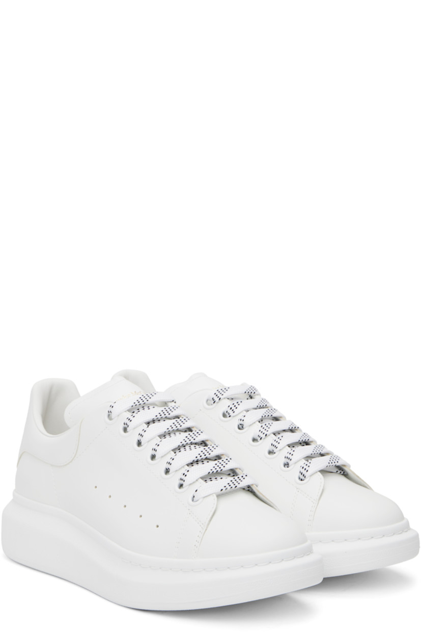 Low-top buffed calfskin sneakers in white.

· Lace-up closure
· Padded tongue and collar
· Gold-tone logo stamp at tongue and heel
· Perforations at sides
· Buffed calfskin lining
· Textured rubber midsole
· Treaded rubber sole

Supplier color: White/White