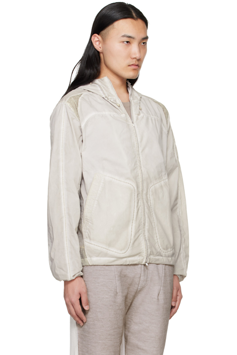 Garment-dyed polyester taffeta jacket. Fading throughout.

· Paneled construction 
· Cord-lock drawstring at hood and hem 
· Two-way zip closure
· Patch pockets
· Sheer plain-woven trim at side seams, shoulders, and sleeves

Supplier color: Gray