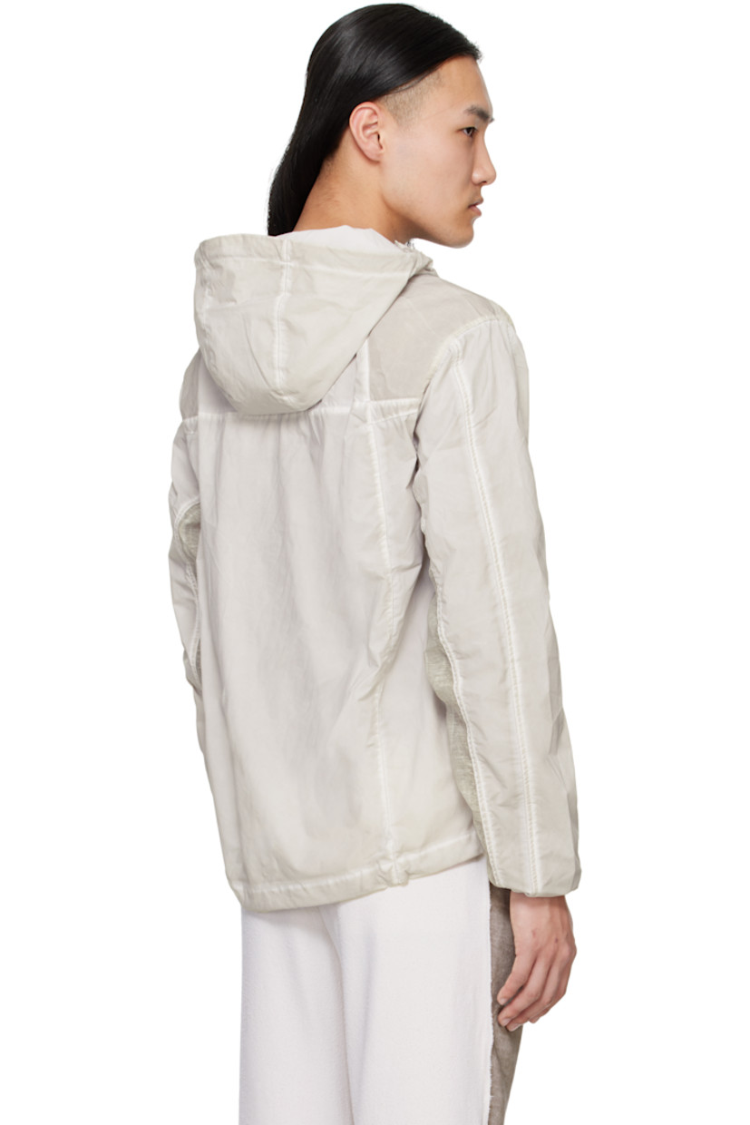 Garment-dyed polyester taffeta jacket. Fading throughout.

· Paneled construction 
· Cord-lock drawstring at hood and hem 
· Two-way zip closure
· Patch pockets
· Sheer plain-woven trim at side seams, shoulders, and sleeves

Supplier color: Gray