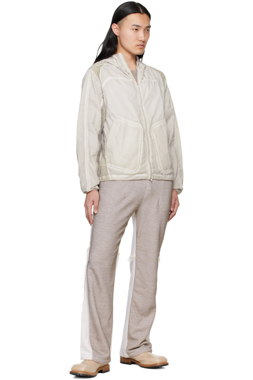 Garment-dyed polyester taffeta jacket. Fading throughout.

· Paneled construction 
· Cord-lock drawstring at hood and hem 
· Two-way zip closure
· Patch pockets
· Sheer plain-woven trim at side seams, shoulders, and sleeves

Supplier color: Gray