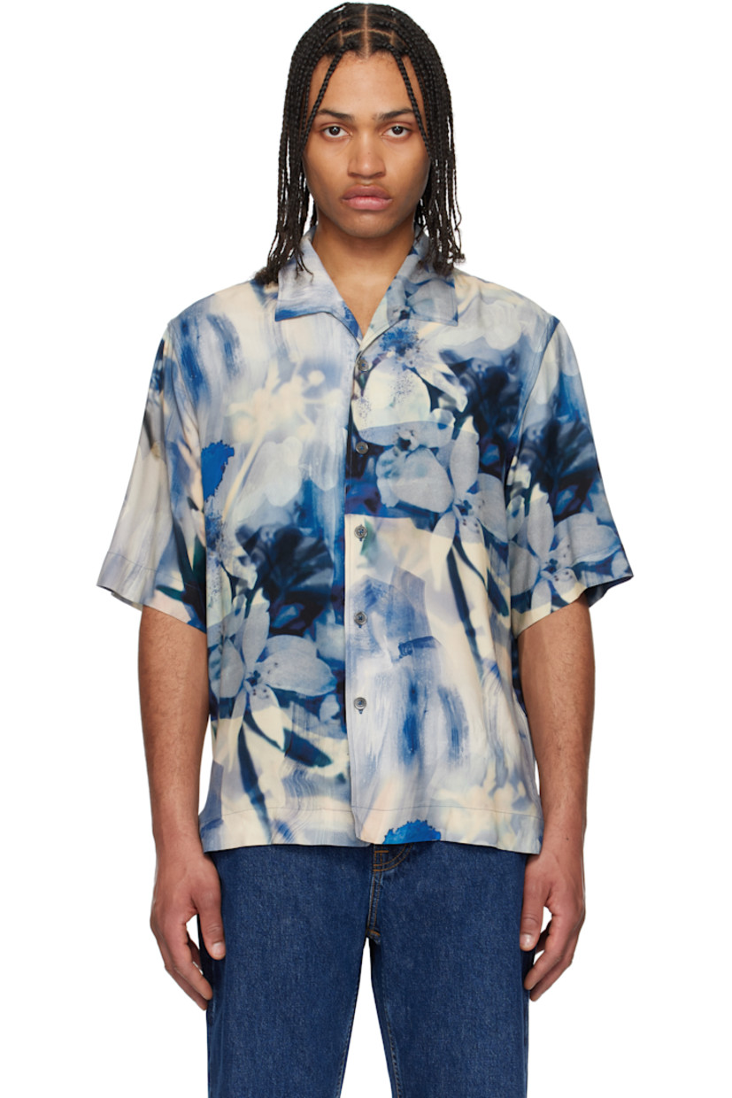 Oversized viscose poplin shirt. Graphic pattern printed throughout.

· Open spread collar
· Button closure
· Vented side seams
· Droptail hem
· Box pleat at back yoke

Supplier color: Blue