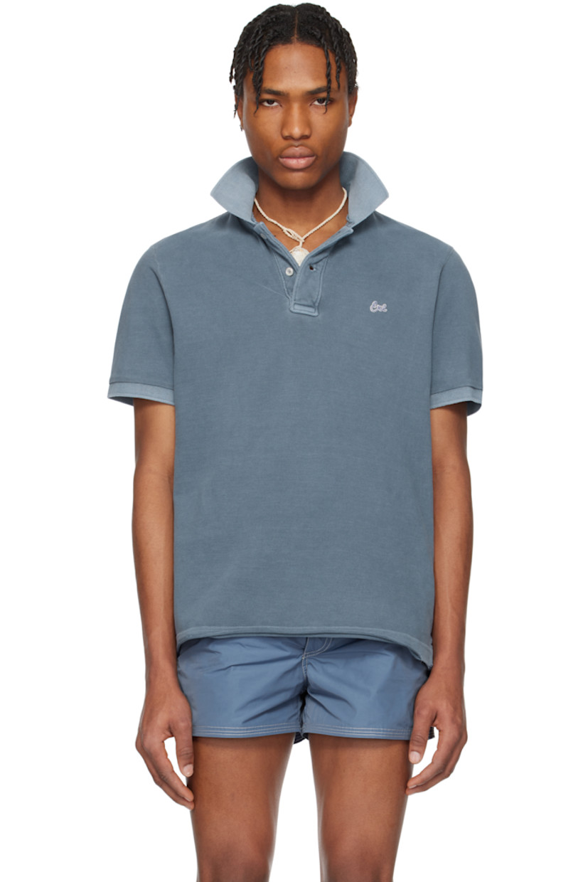 Cotton piqué polo. Fading throughout.

· Rib-knit spread collar and cuffs
· Two-button placket
· Embroidered logo patch at chest
· Raw and rolled edge at tennis-tail hem

Supplier color: Navy