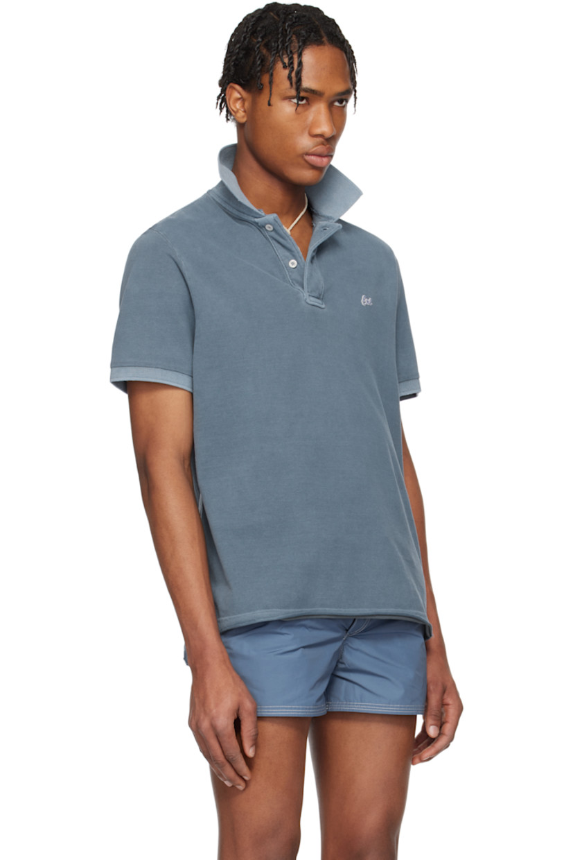 Cotton piqué polo. Fading throughout.

· Rib-knit spread collar and cuffs
· Two-button placket
· Embroidered logo patch at chest
· Raw and rolled edge at tennis-tail hem

Supplier color: Navy