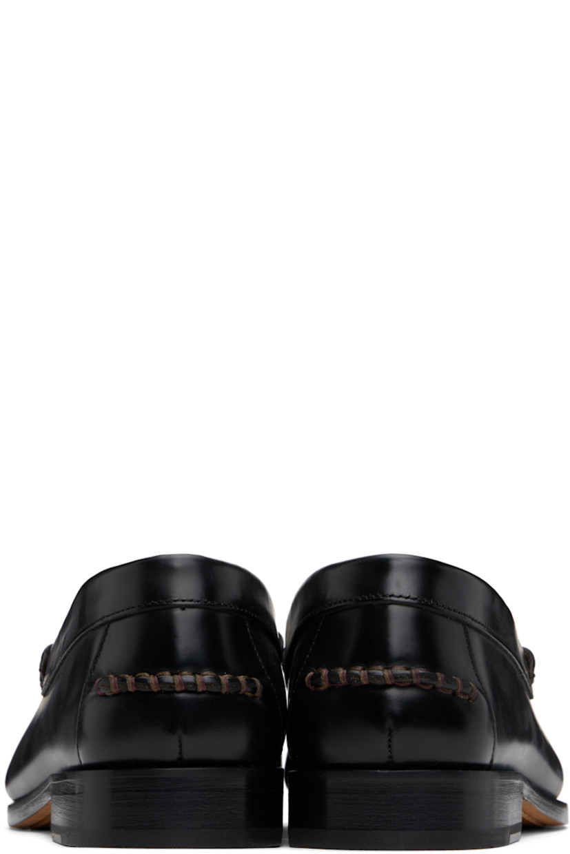 Polished calfskin loafers in black.

· Moc toe
· Blanket stitching at toe and heel counter
· Logo and strap with cutout at vamp
· Pinched seam at heel counter
· Stacked leather block heel with rubber injection
· Floral graphic embossed at polished leather sole
· Heel: H1"

Supplier color: Black