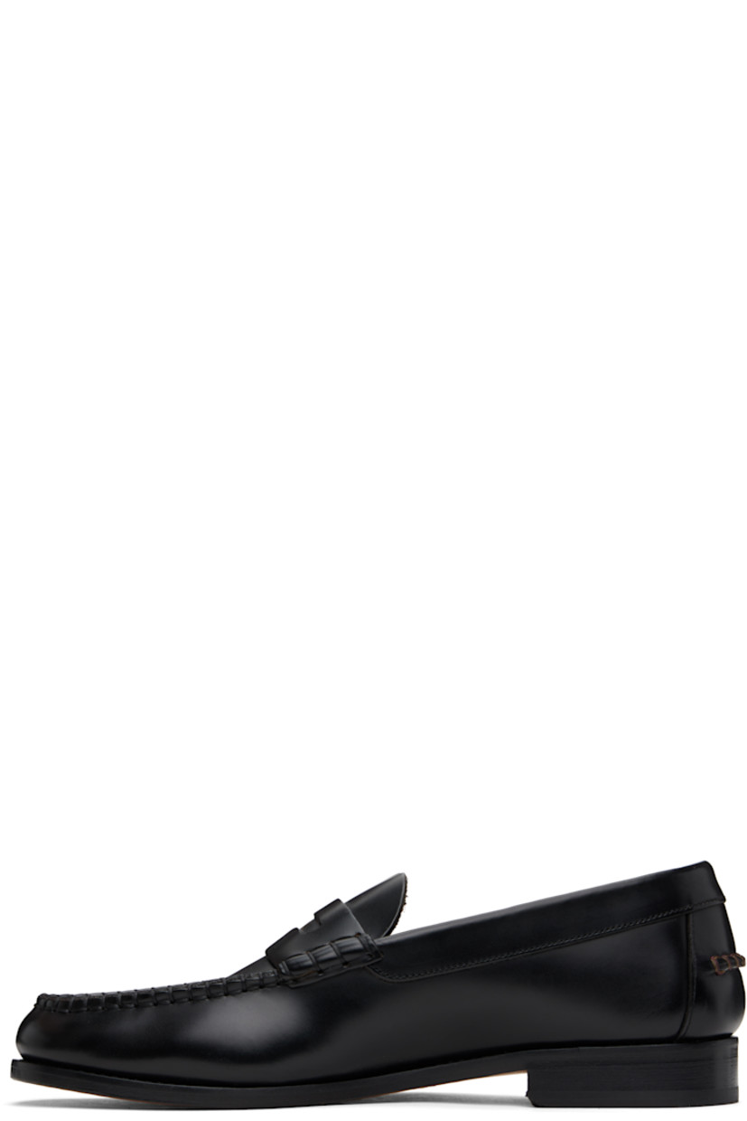 Polished calfskin loafers in black.

· Moc toe
· Blanket stitching at toe and heel counter
· Logo and strap with cutout at vamp
· Pinched seam at heel counter
· Stacked leather block heel with rubber injection
· Floral graphic embossed at polished leather sole
· Heel: H1"

Supplier color: Black