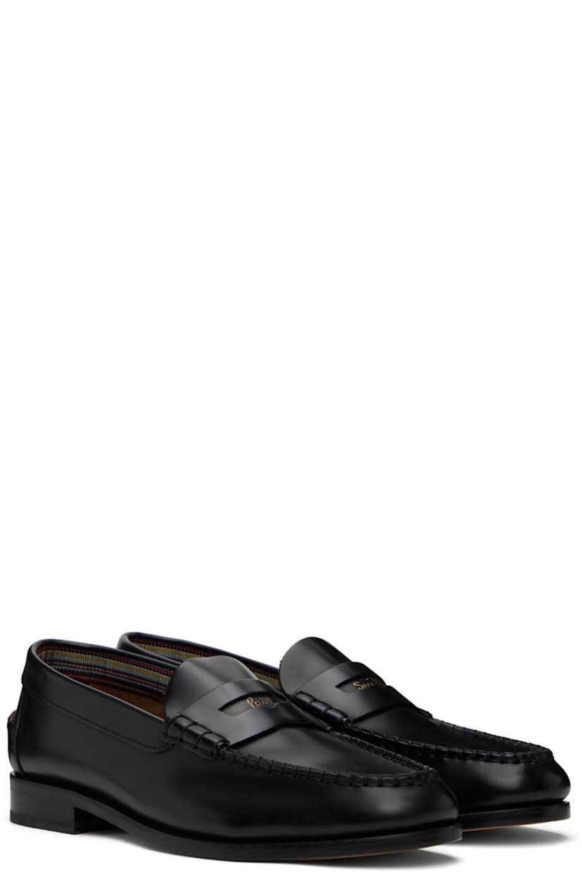 Polished calfskin loafers in black.

· Moc toe
· Blanket stitching at toe and heel counter
· Logo and strap with cutout at vamp
· Pinched seam at heel counter
· Stacked leather block heel with rubber injection
· Floral graphic embossed at polished leather sole
· Heel: H1"

Supplier color: Black