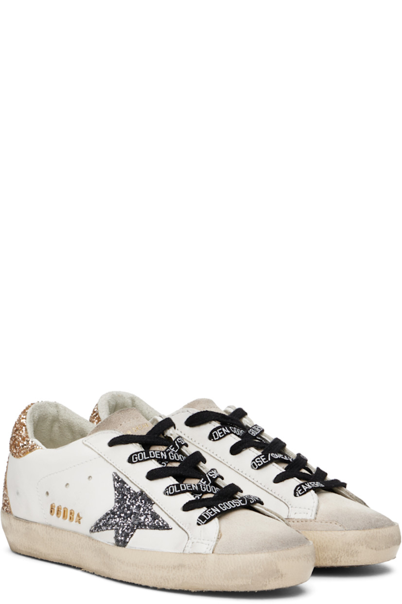 Handcrafted low-top paneled suede and buffed leather sneakers in off-white.

· Smudging and glittered detailing throughout
· Lace-up closure
· Logo stamped at tongue
· Padded collar
· Perforated detailing at sides
· Signature star appliqué at outer side
· Logo hardware at outer side
· Logo printed at heel tab
· Suede, buffed leather, and terrycloth lining
· Treaded rubber sole

Supplier color: Optic white/Seedpearl
