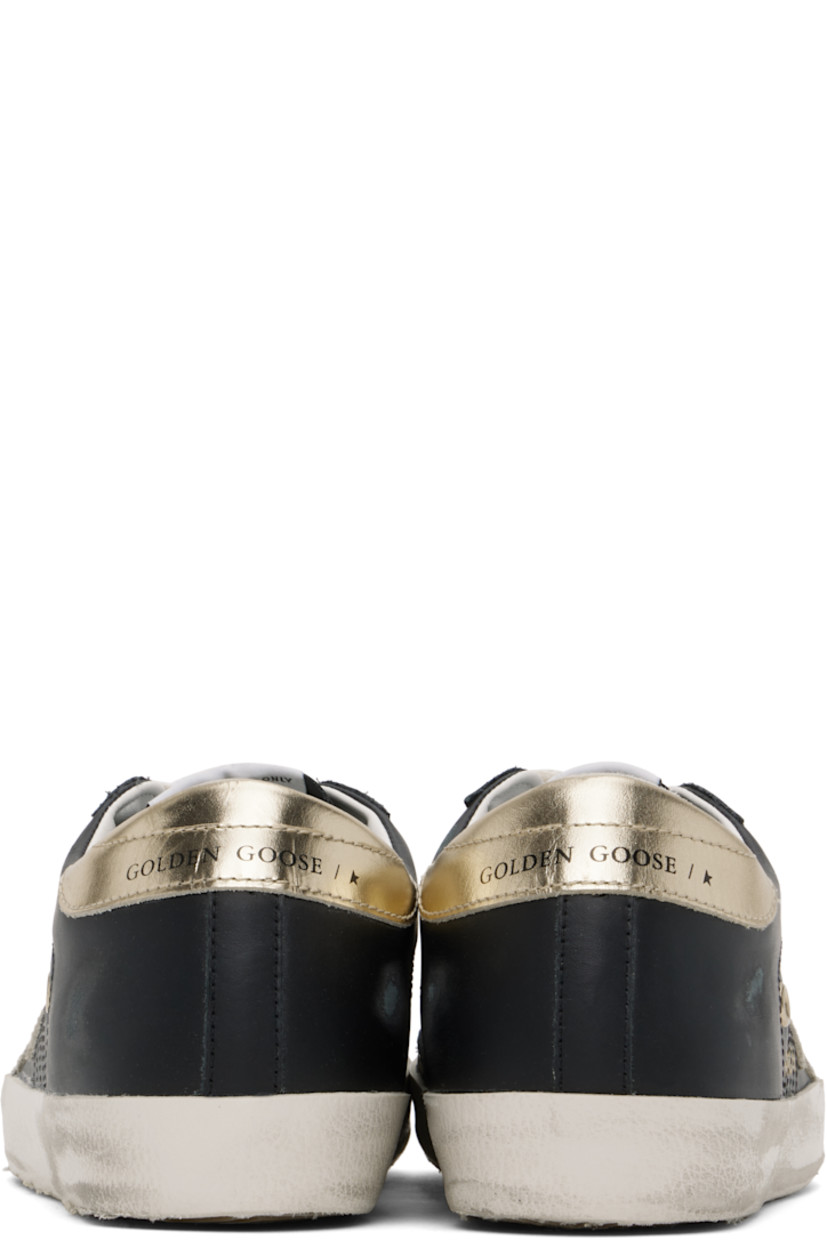 Handcrafted low-top buffed leather sneakers in black.

· Smudging and distressing throughout
· Lace-up closure
· Logo patch at tongue
· Padded collar
· Signature star appliqué at outer side
· Gold-tone logo stamp 
· Eyelet vents at sides
· Logo printed at heel tab
· Buffed leather, suede, and terrycloth lining
· Treaded rubber sole

Supplier color: Black/Gold